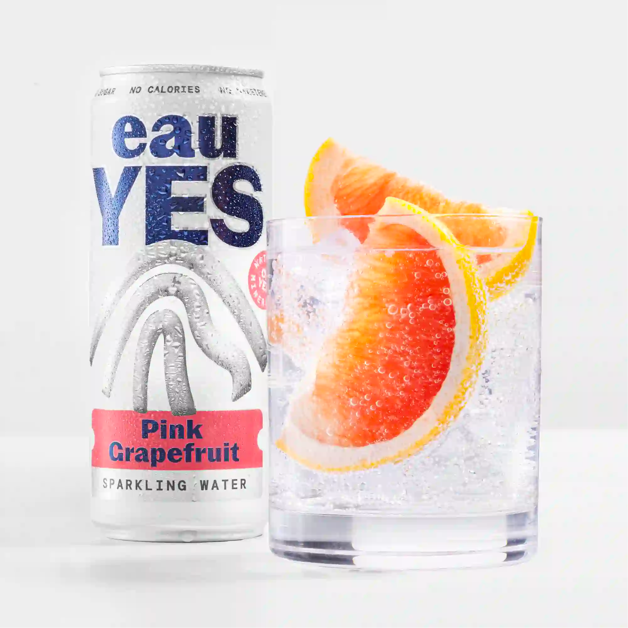 eauYES water pink grapefruit sparkling water can and glass