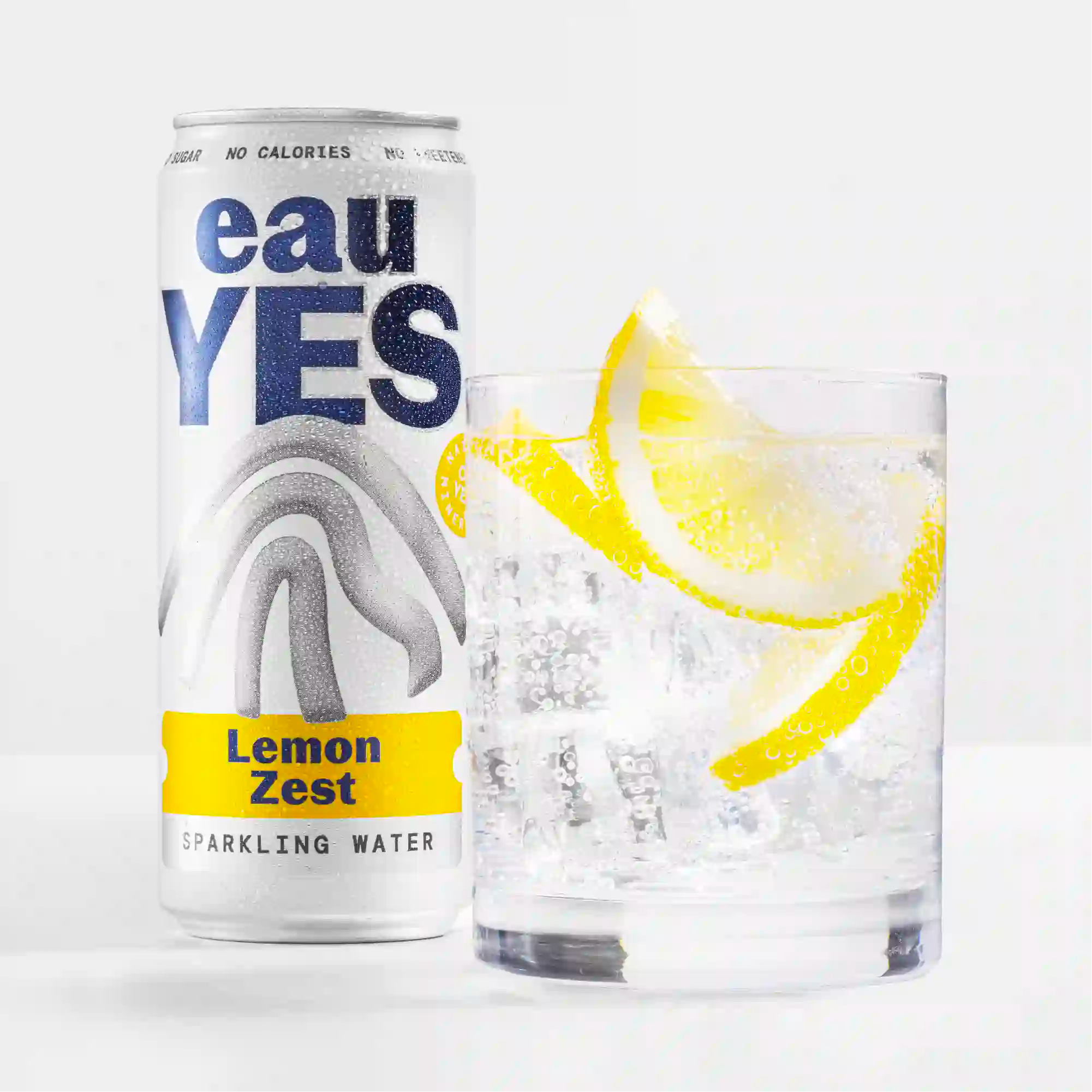 eauYES water lemon zest sparkling water can and glass